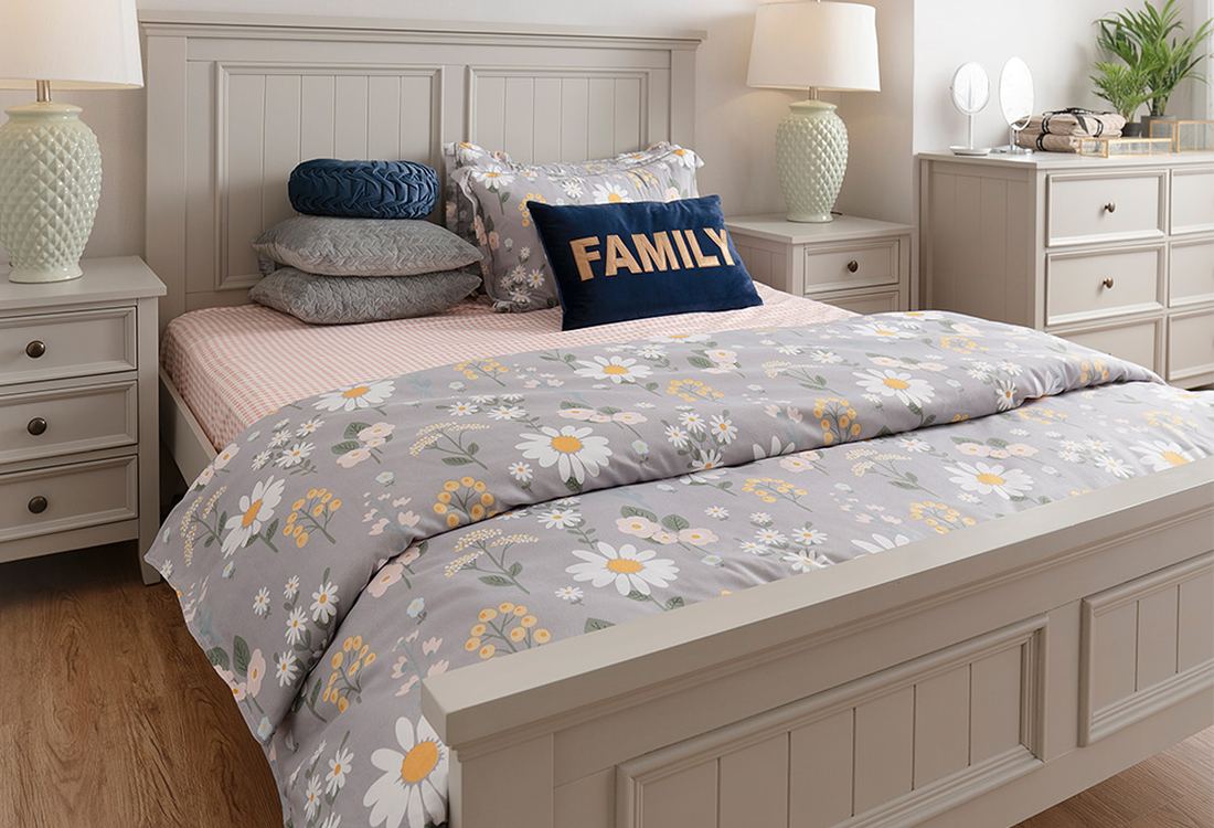 Bedroom with layered bedding and bedside lamps